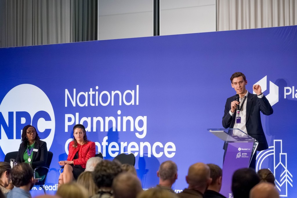 Planning professionals presenting and seated on stage at the National Planning Conference.