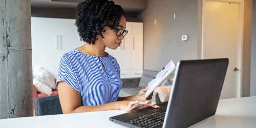Woman working at laptop in modern, well-lit room