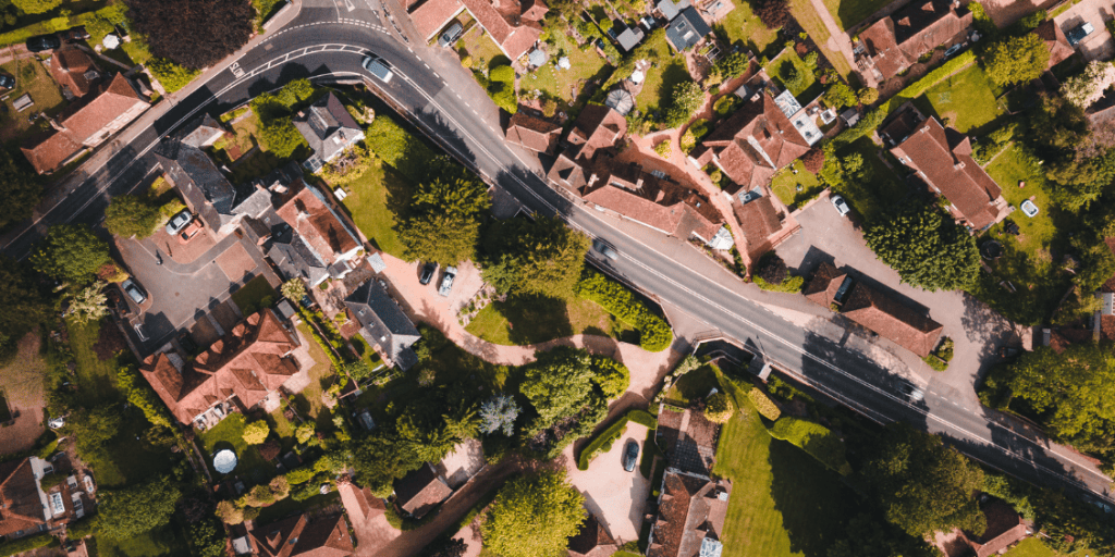 Aerial view of houses and roads within a residential settlement.