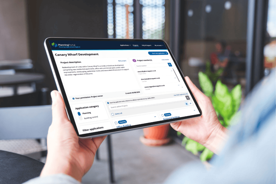 Hands holding a tablet displaying the Planning Portal Projects platform, with a project application interface visible on screen.