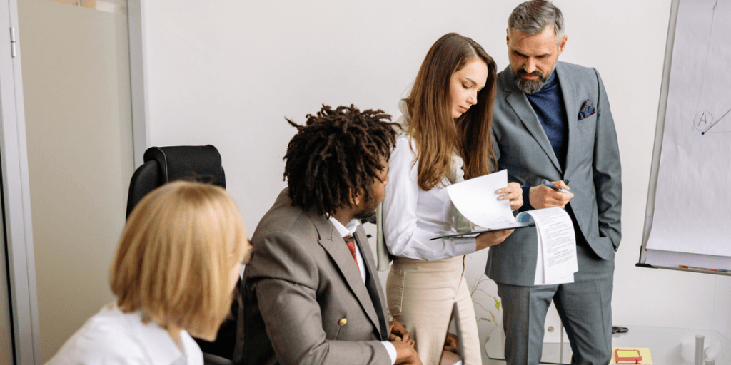 Local authority professionals reviewing documents during a meeting in an office, discussing planning applications and decisions.